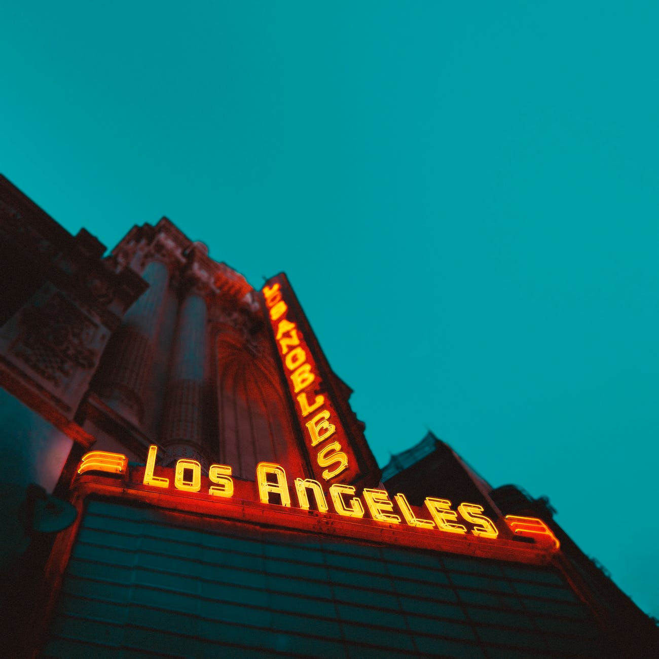 low angle photography of brown building with los angeles led sign